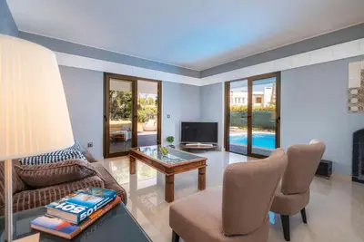 a living room with a couch and a table and a tv at Balaia Retreat - Nature & Beach in Olhos de Água