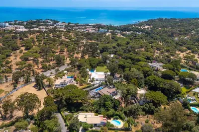 an aerial view of a house with trees and the ocean at Balaia Retreat - Nature & Beach in Olhos de Água
