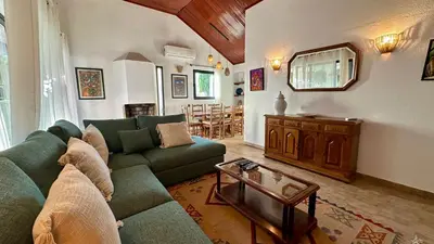 a living room with a green couch and a table at Gemini by Check-in Portugal in Albufeira
