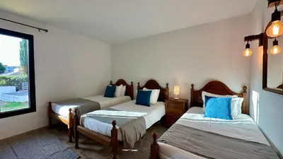 a room with three beds and a window at Gemini by Check-in Portugal in Albufeira