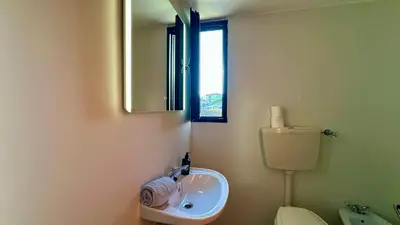 a bathroom with a sink and a mirror and a toilet at Gemini by Check-in Portugal in Albufeira