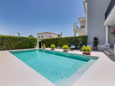 two beds in a room with a window at Casa Barakat with Pool and BBQ in Vale do Lobo in Quinta do Lago