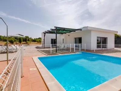 a villa with a swimming pool and a house at Villa Brown's with Private Pool in Vilamoura in Quarteira