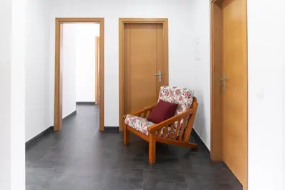a rocking chair in a hallway with a door at Villa Brown's with Private Pool in Vilamoura in Quarteira