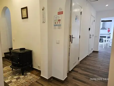 a hallway with a door and a suitcase on the floor at Blife Castelya private property in Faro