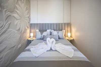 a bedroom with a bed with two towels on it at NEW! Dream Terrace Albufeira Ocean and Pool Views in Bicas