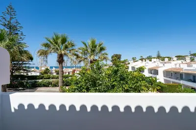 a view from the balcony of a building with palm trees at Bmyguest - Vale do Lobo Family Beach Villa in Vale do Lobo