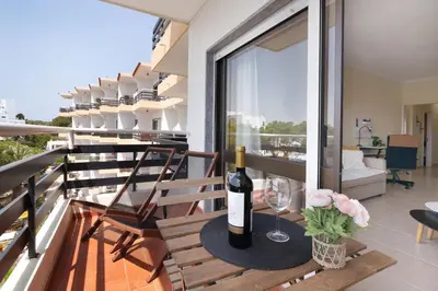 a room with a desk with a chair and a bed at Marbel Sol Apartment Al in Quarteira