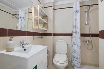 a bathroom with a toilet and a sink and a shower at Marbel Sol Apartment Al in Quarteira