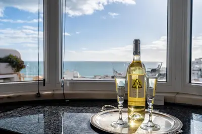 a bottle of wine on a table with two glasses at Prestige Flat by Albufeira Holidays in Albufeira