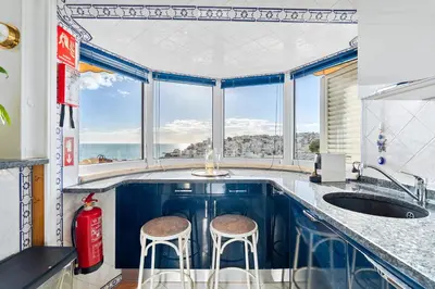a kitchen with a sink and two stools at Prestige Flat by Albufeira Holidays in Albufeira