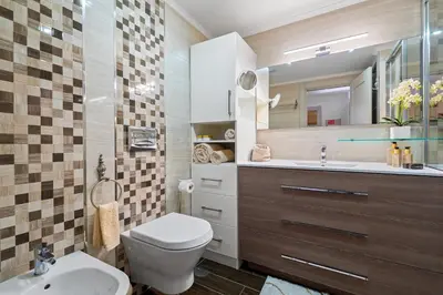 a bathroom with a toilet and a sink and a mirror at Prestige Flat by Albufeira Holidays in Albufeira