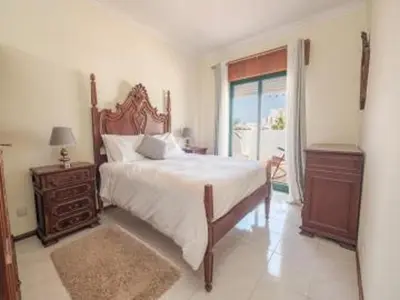 a bedroom with a large bed and a window at Faro Charm Apartment - City Center in Faro