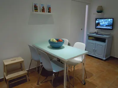 a dining room with a table with a bowl of fruit on it at Charming House in Albufeira with Shared Pool in Albufeira