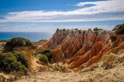 a view of a rocky mountain near the ocean at Charming House in Albufeira with Shared Pool in Albufeira
