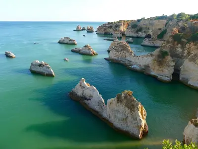 a group of large rocks in the water at Charming House in Albufeira with Shared Pool in Albufeira