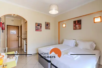 a bedroom with a bed with a home holidays sign on it at #324 Ribeira Park by Home Holidays in Albufeira