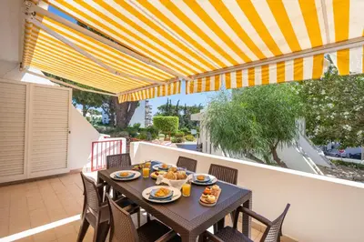a table with food on it on a patio at HostWise - Sunny Escape with a Pool & Balcony in Vilamoura