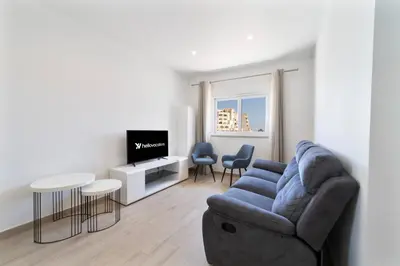 a living room with a couch and chairs and a tv at Golden View Villa by HelloVacations in Albufeira