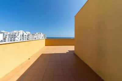 a balcony with a view of the ocean and buildings at Golden View Villa by HelloVacations in Albufeira