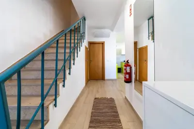 a hallway with stairs and a fire extinguisher at Golden View Villa by HelloVacations in Albufeira