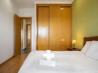 a bedroom with a bed with towels on it at Akivillas Albufeira Repose in Albufeira