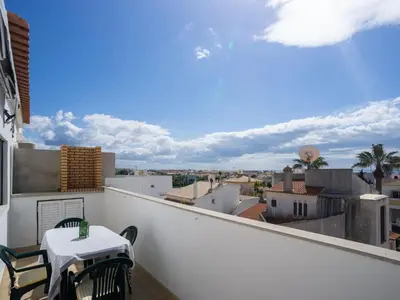 a balcony with a table and chairs and a view at Akivillas Albufeira Repose in Albufeira