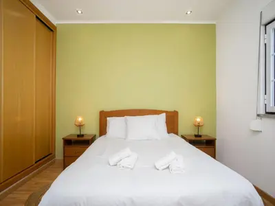 a bedroom with a large white bed with two night stands at Akivillas Albufeira Repose in Albufeira