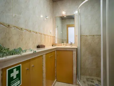 a bathroom with a shower and a sink and a mirror at Akivillas Albufeira Repose in Albufeira