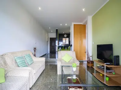 a living room with a couch and a tv at Akivillas Albufeira Repose in Albufeira