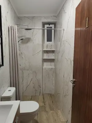 a white bathroom with a toilet and a sink at Simply House in Faro