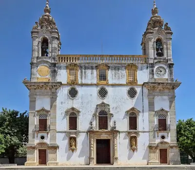 an old building with a clock tower on it at Simply House in Faro
