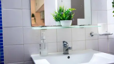 a bathroom with a sink with a bottle on it at Bayview Old Town Beach Apartment in Albufeira