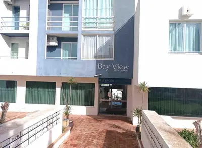 a large white building with a bay view sign on it at Bayview Old Town Beach Apartment in Albufeira