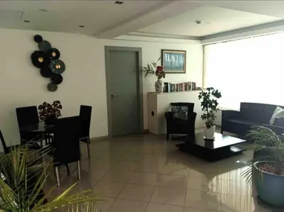 a living room with a table and chairs at Bayview Old Town Beach Apartment in Albufeira