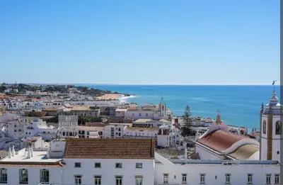 a view of a city with the ocean in the background at Bayview Old Town Beach Apartment in Albufeira