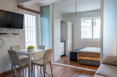 a room with a table and a bed and a mirror at Bayview Old Town Beach Apartment in Albufeira
