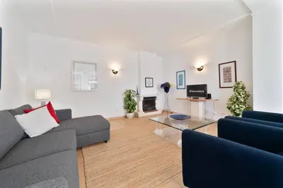 a living room with a couch and a table at Tangerine Apartment by HelloVacations in Albufeira