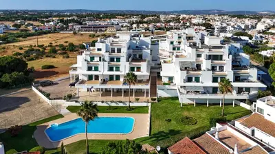 an aerial view of a large apartment complex with a swimming pool at Tangerine Apartment by HelloVacations in Albufeira