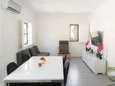 a living room with a white table and chairs at Delta Marina in Vilamoura