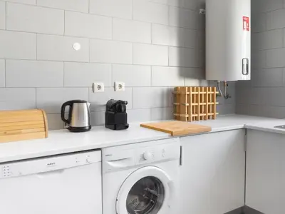 a kitchen with a washer and dryer on a counter at Delta Marina in Vilamoura