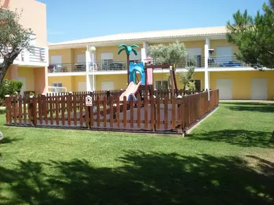 a wooden fence in front of a building at Encosta Sao Jose - Apartment V in Albufeira