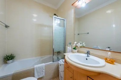 a bathroom with a sink and a bath tub at Encosta Sao Jose - Apartment V in Albufeira