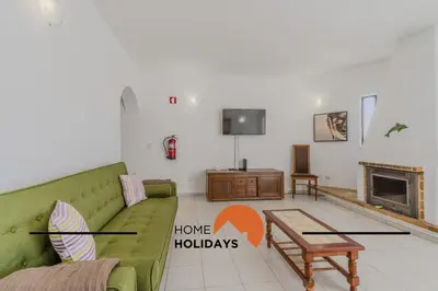 a living room with a green couch and a fireplace at #295 Beco do Sol 29A by Home Holidays in Albufeira