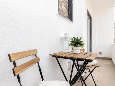 a small table in a room with a plant on it at Akisol Faro Cobalt in Faro