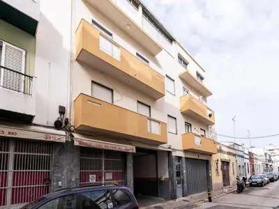 a building on a street with cars parked in front of it at Akisol Faro Cobalt in Faro