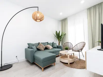a living room with a blue couch and a table at Akisol Faro Cobalt in Faro