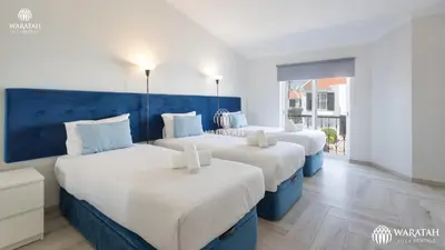 two beds in a room with blue and white at Apartamento Fairway in Loulé