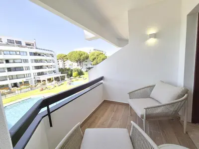 a balcony with a view of a swimming pool at Vilamoura Collection in Quarteira