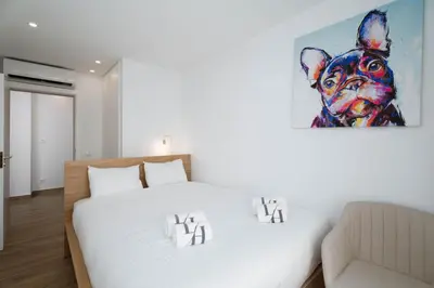 a bedroom with a bed and a painting of a pig at Vilamoura Collection in Quarteira